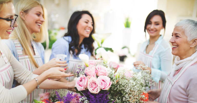 Women gathering and smiling at a Charity Karats fundraiser party